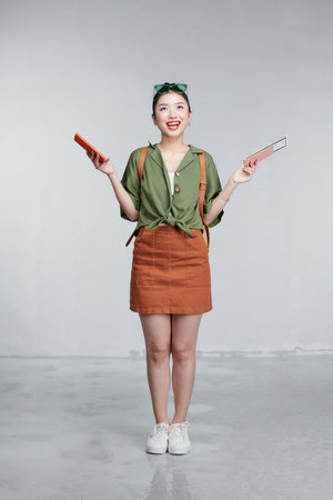 Traveler tourist woman hold passport boarding ticket mobile cell phoneの写真素材