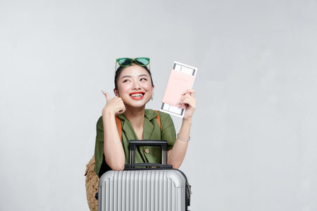Cheerful woman passport and plane ticket vacation airportの写真素材