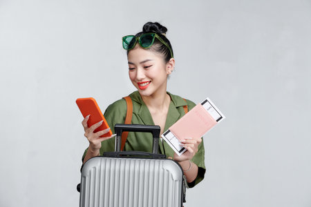 happy woman girl with suitcase and passport over gray backgroundの写真素材