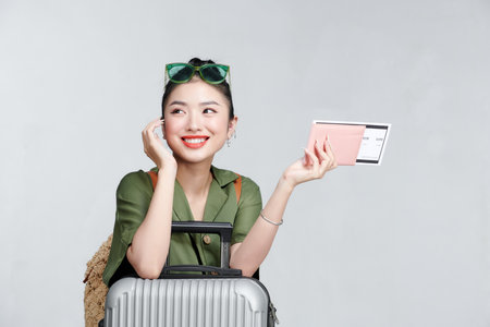Beautiful travel woman with passport isolated on white backgroundの写真素材