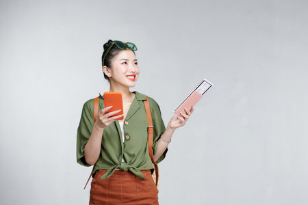 Traveler tourist woman hold passport boarding ticket mobile cell phoneの写真素材