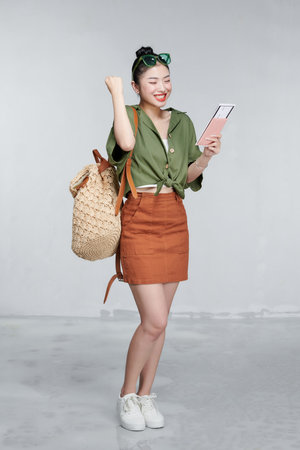Portrait beautiful young asian woman with backpack travel bag with passport and boarding pass ticketの写真素材