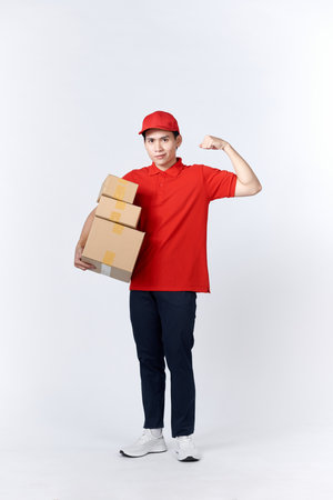 Portrait of Strong handsome delivery man flexing his muscle and holding pizza box packages.の写真素材
