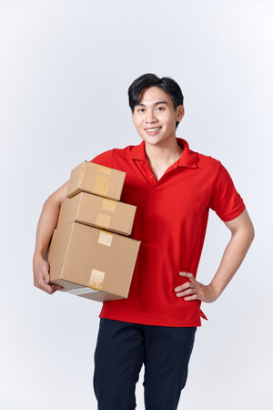 Portrait smiling Asian man holding post boxes standing over isolated background with copy space.の写真素材