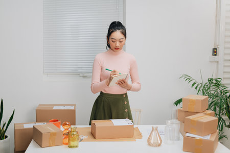 Portrait Asian small business owner warehouse home office, online market packing delivery.の写真素材