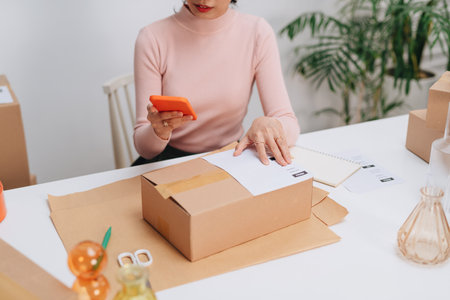 taking note of orders from customers with mobile phones.の写真素材