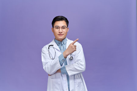 portrait of smiley medical doctor pointing at something.の写真素材