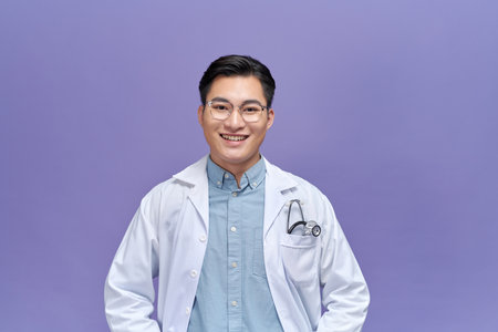 Pediatrician with stethoscope on  purple background, space for textの写真素材