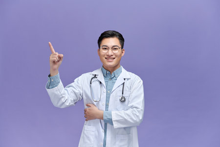 Medical concept of professional male doctor pointing with hand on copy spaceの写真素材