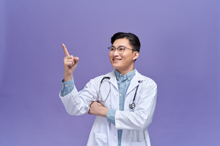 Smart young doctor pointing at somethingの写真素材