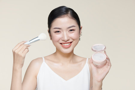Powder blush woman Asian appearance smile and makeup brushの写真素材