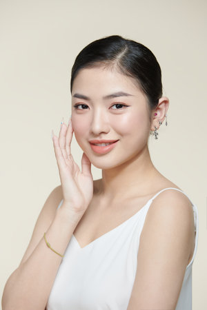 Pretty young female model with fresh healthy glowing skin, modern make upの写真素材