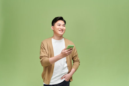 portrait of happy young man reading mobile sreenの写真素材
