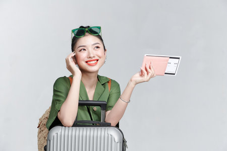 Traveler woman hold suitcase passport ticket isolated on plain white backgroundの写真素材