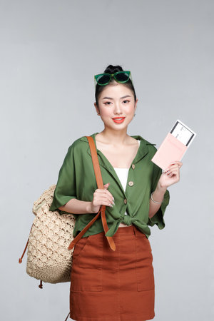 Excited happy tourist woman with passport, ticket  isolated on white backgroundの写真素材