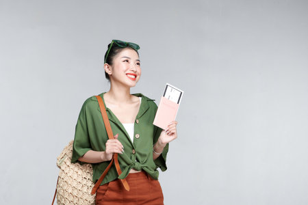 Beautiful travel woman with passport isolated on white backgroundの写真素材