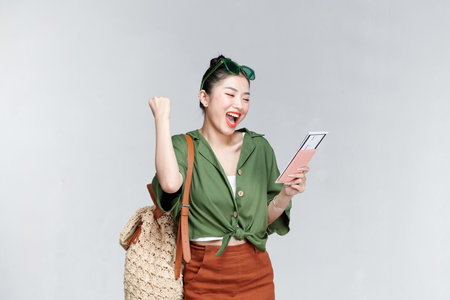 Traveler fun woman wear casual clothes hold passport ticket do winner gestureの写真素材