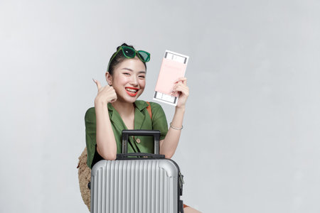 fashionable woman with suitcase passport plane tickets travelの写真素材