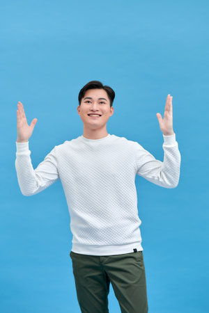 Young attractive handsome funny man excited fists up and celebrate hooray winner of tournamentの写真素材