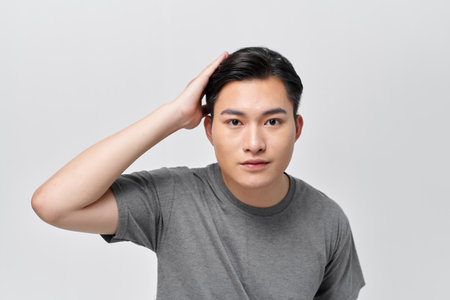 Handsome male model touching his hairの写真素材