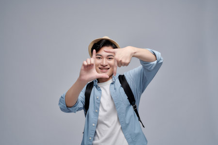 Photo of attractive charming young man make fingers frame picture smileの写真素材