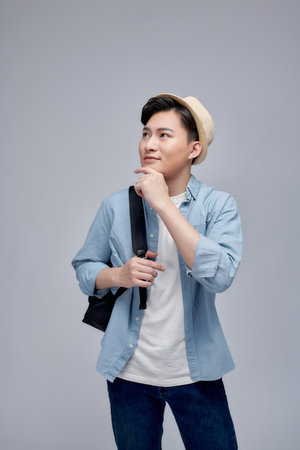 Cheerful traveler wearing backpack and hatの写真素材