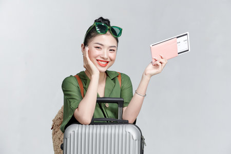 fashionable woman with suitcase passport plane tickets travelの写真素材