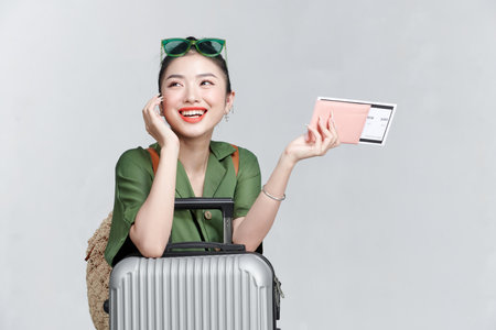 Traveler woman hold suitcase passport ticket isolated on plain white backgroundの写真素材