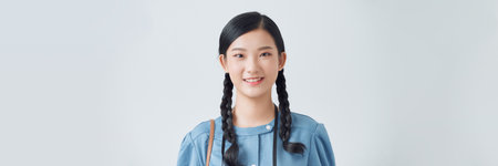 Young asian woman portrait in blue dress. Soft sunny colors.の写真素材