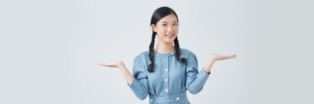 A Asian woman making a happy gesture with both of her palms open as if holding somethingの写真素材