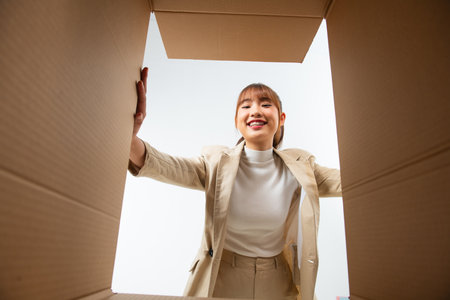 Joyful female customer satisfied with fast delivery service, getting parcel, shipping concept.