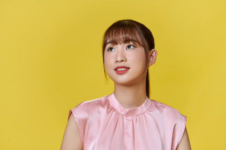 Photo of wonderful female model isolated on yellow background.の写真素材