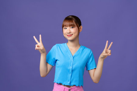 Asian college girl V sign and smileの写真素材