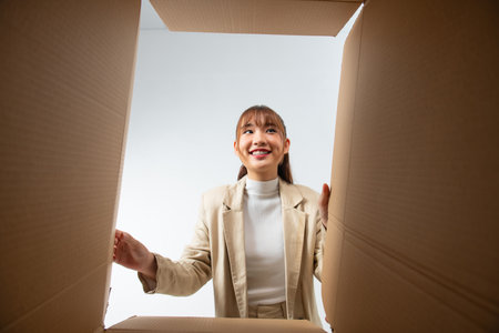 Happy woman with open box, view from insideの写真素材