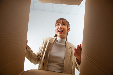 Woman with open box, view from inside. Surprise.の写真素材
