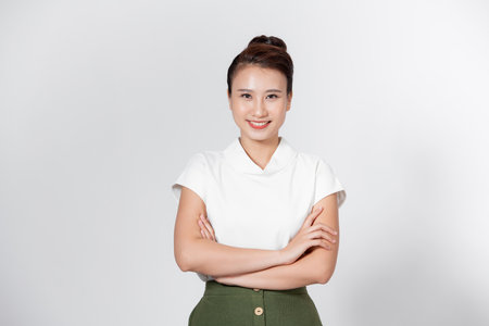 Pretty girl with crossed hands wearing white shirt midi skirt footwear isolated white backgroundの写真素材