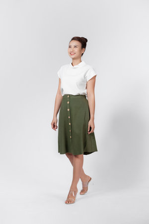 Happy carefree woman with joyful expression, smiling while standing in relaxed pose against white background,の写真素材