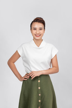 Happy carefree woman with joyful expression, smiling while standing in relaxed pose against white background,の写真素材