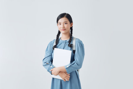 Smiling female student enhancing her future by attending regular lecturesの写真素材