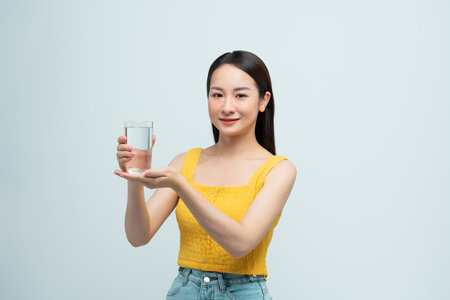 young attractive asian woman who drinks waterの写真素材