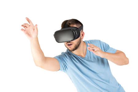 Young man playing with a VR glasses on a white backgroundの写真素材