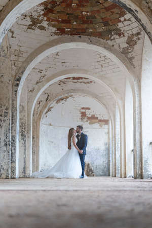 Portrait of a young wedding couple under archesの写真素材