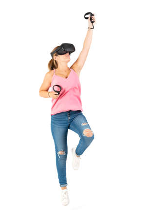Young woman playing with a VR glasses on a white backgroundの写真素材