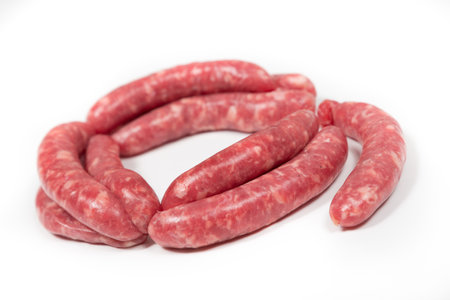 Many crude sausages on a white backgroundの写真素材