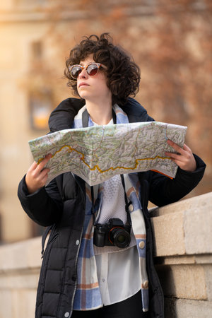 Young tourist woman searching in the city with a mapの写真素材