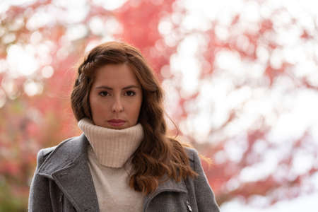 Close-up portrait of a young woman looking at camera very serious