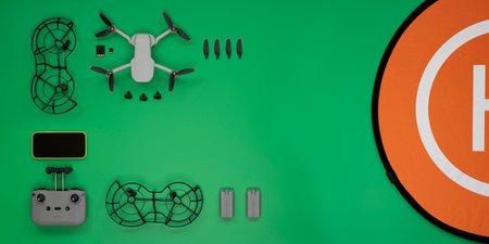 Top view of green background table with some drone accessories.の写真素材