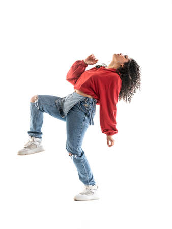 Latin brunette woman dancing in studio with white background