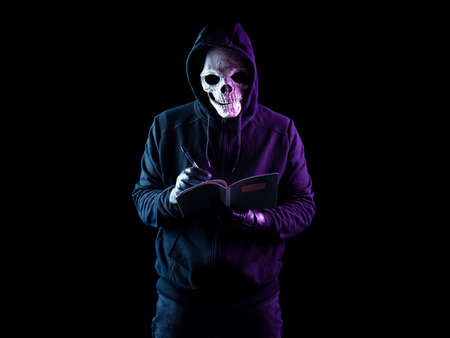 Modern death character on a black background taking notesの写真素材
