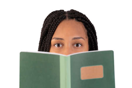 Young black woman reading a notebook and looking at cameraの写真素材